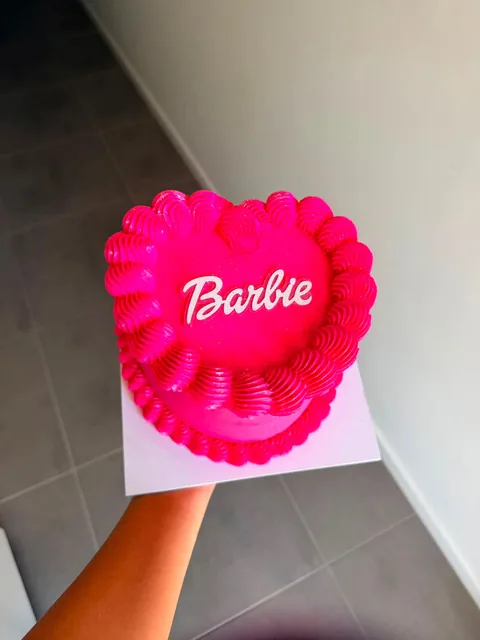 Hot pink vintage heart cake with scalloped piping and Barbie written in white